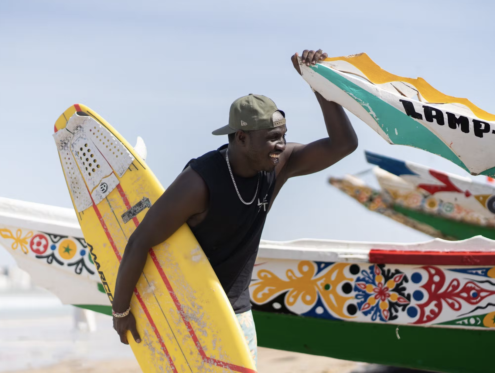 Babacar Thiaw with surfboards in Senegal